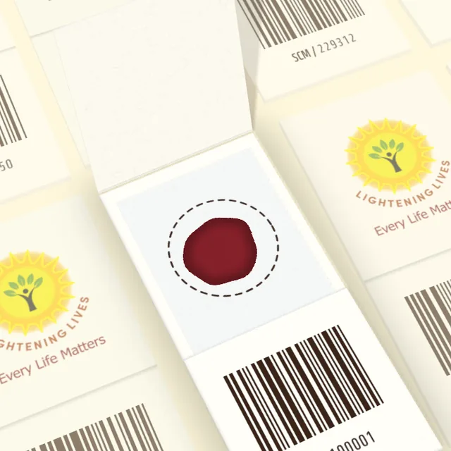 An open dried blood spot card seen from above: a single dried blood spot inside one dashed collection circle.