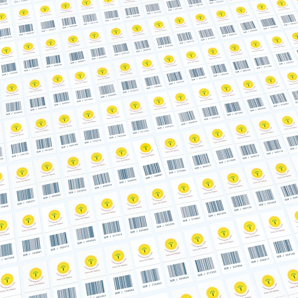 The same card, now closed, set down in a grid of many others that each carry the Lightening Lives logo and a barcode.