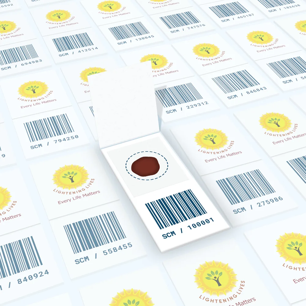 The open card seen from above: a single dried blood spot inside its dashed collection circle, above a barcode and sample code.